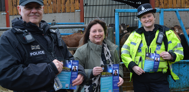 Sgt Mark Earnshaw Commissioner Zoe Insp Julie-Earnshaw holding protect your home leaflet on a farm