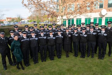 Police officers group together for a formal photo