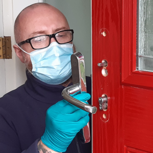 Fitter Lee Harrison refitting the door handle after upgrading the lock to a secure anti snap lock meeting Secured by Design standard
