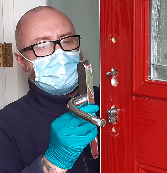 Fitter Lee Harrison refitting the door handle after upgrading the lock to a secure anti snap lock meeting Secured by Design standard