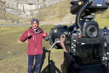 Lady with thumbs up standing in front of video camera