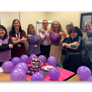 Commissioner and Staff at the OPFCC pose to embrace equity on International Women's Day