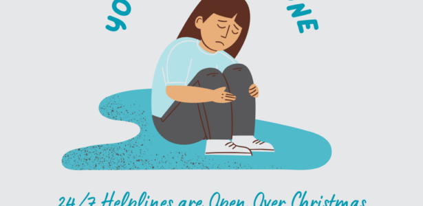 Person with a blue tshirt and grey trousers sitting down in a puddle holding their knees to their chest. The words above them read 'you are not alone' and under '24/7 Helplines are Open Over Christmas.