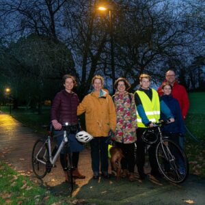 (From left to right) Katie Birks, Elaine Hiser, Fiona Protheroe, Will Hiser-Dobson, Isla Hiser Dobson and Richard Dobson in Skipton’s Aireville Park, where new lighting has been introduced. Also pictured are their four-legged friends Tiree and Coll (far right).