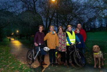 (From left to right) Katie Birks, Elaine Hiser, Fiona Protheroe, Will Hiser-Dobson, Isla Hiser Dobson and Richard Dobson in Skipton’s Aireville Park, where new lighting has been introduced. Also pictured are their four-legged friends Tiree and Coll (far right).