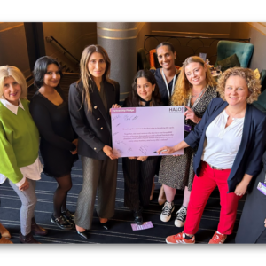 Yasmin Khan Director of The Halo Project and Jo Coles Deputy Mayor for Policing Fire and Crime with members of the Halo team holding the partnership pledge