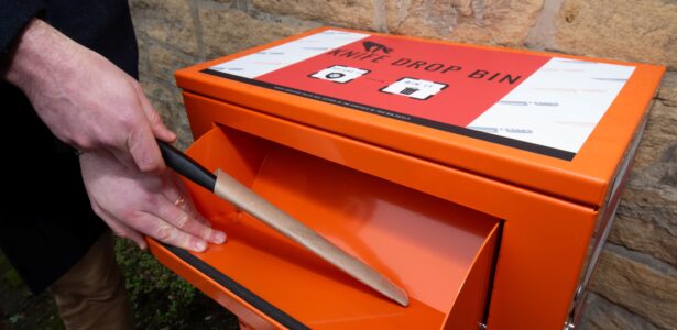 Knife being posted into knife bin.